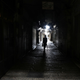A man walks past closed shops in Jerusalem’s Old City.